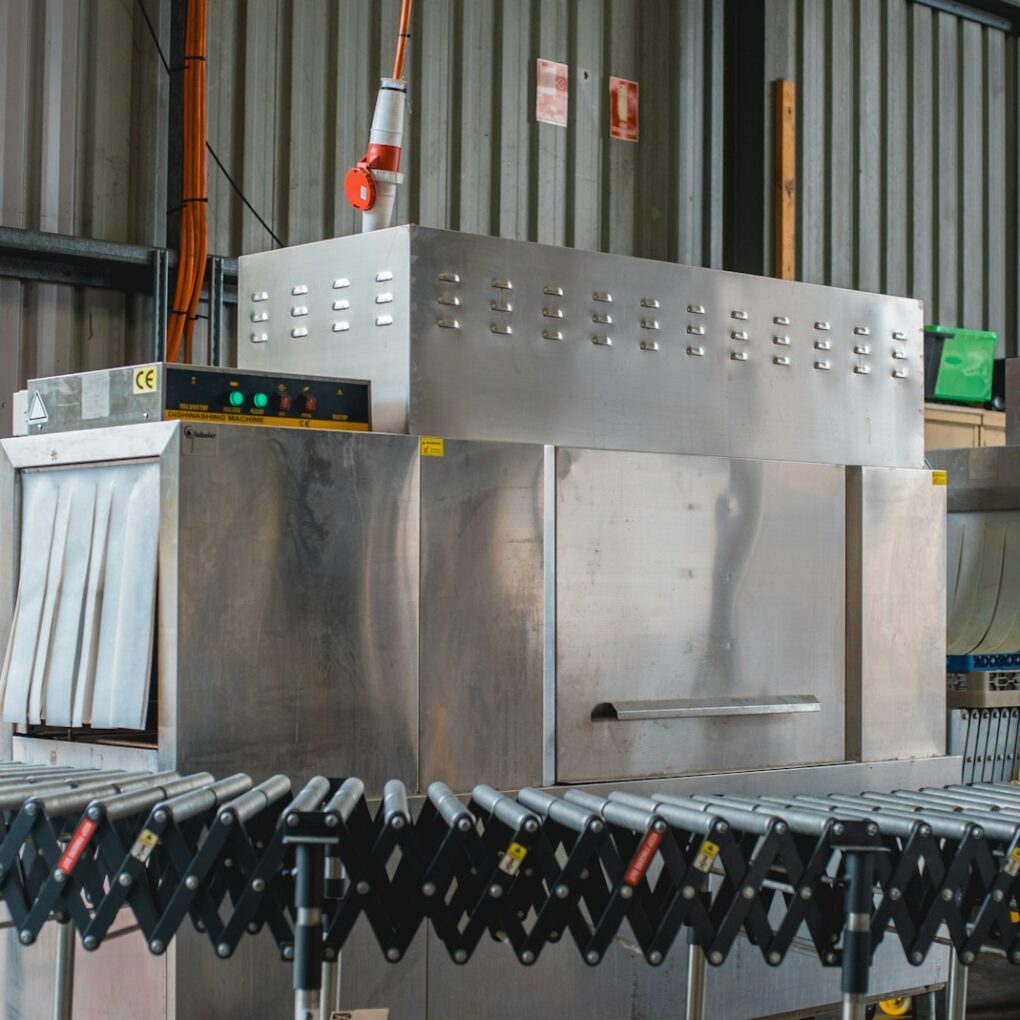 turned-on gray converyor machine