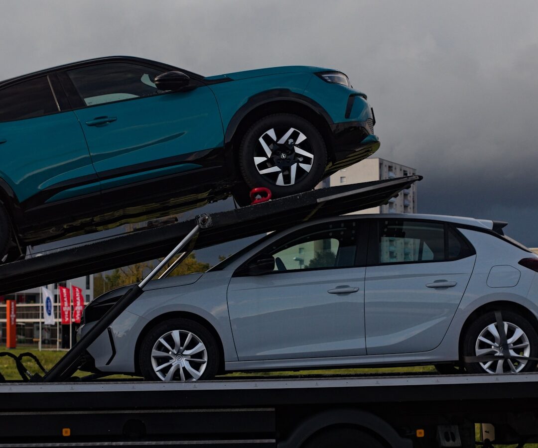 Two cars loaded onto a car carrier truck.