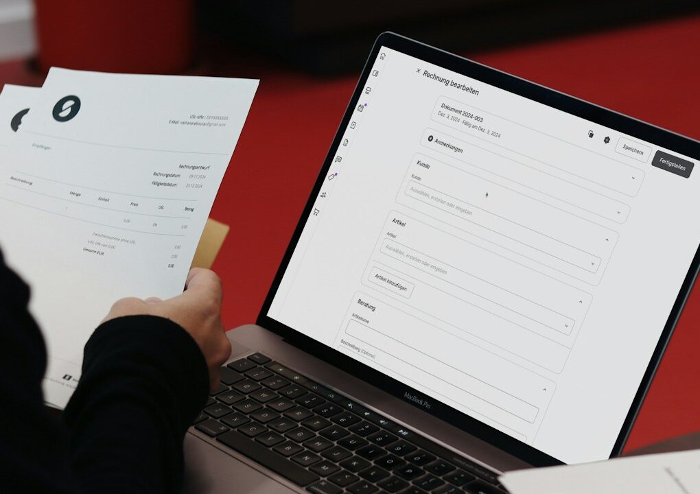 A person sitting at a desk with a laptop and papers
